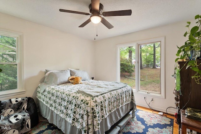 104 Argyle Ct, Garner, NC 27529 - bedroom featuring a ceiling fan, wood finished floors, and a textured ceiling