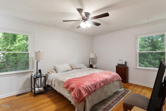 104 Argyle Ct, Garner, NC 27529 - bedroom with light wood-type flooring, visible vents, and ornamental molding