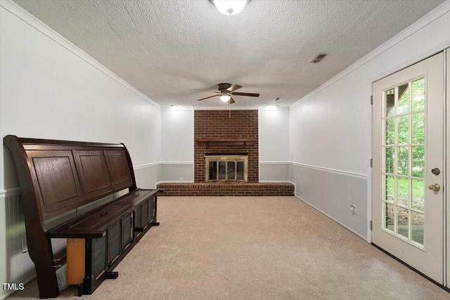 104 Argyle Ct, Garner, NC 27529 - unfurnished living room featuring a ceiling fan, light colored carpet, a textured ceiling, and ornamental molding