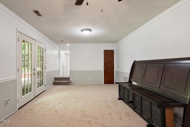 104 Argyle Ct, Garner, NC 27529 - carpeted spare room featuring wainscoting, ceiling fan, french doors, and ornamental molding