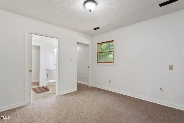 104 Argyle Ct, Garner, NC 27529 - unfurnished bedroom with a textured ceiling, ensuite bathroom, baseboards, light colored carpet, and ornamental molding