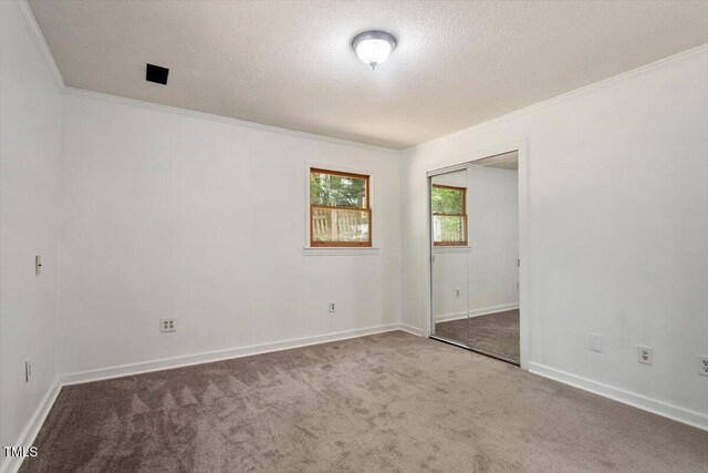 104 Argyle Ct, Garner, NC 27529 - carpeted spare room with a textured ceiling, baseboards, and ornamental molding