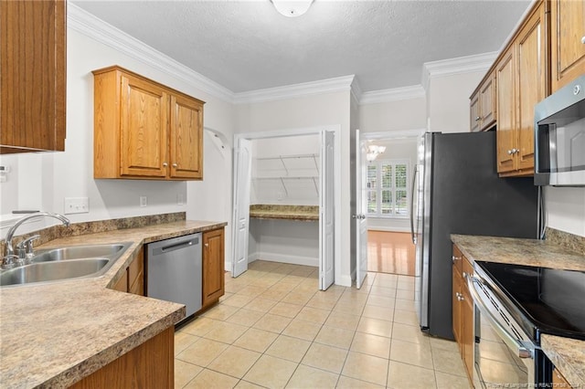 kitchen with crown molding, sink, light tile patterned floors, stainless steel appliances, and a chandelier