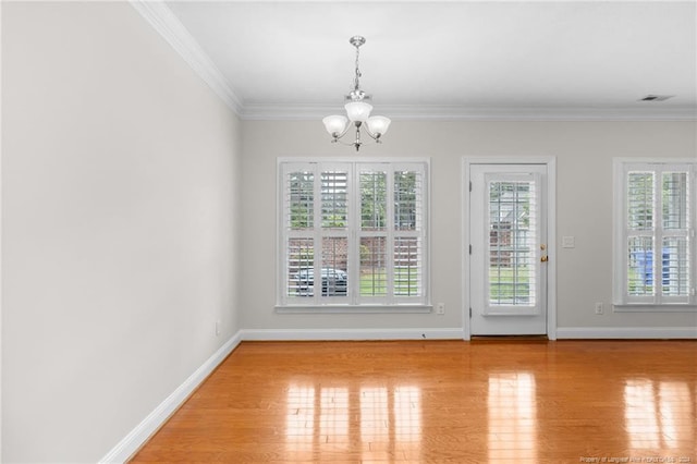 interior space with crown molding, light hardwood / wood-style floors, and a notable chandelier