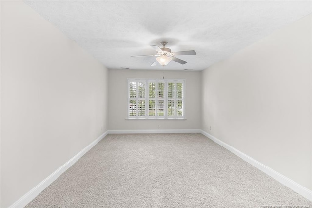 spare room with carpet floors and ceiling fan