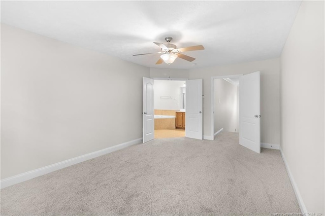 unfurnished bedroom featuring connected bathroom, ceiling fan, and light colored carpet