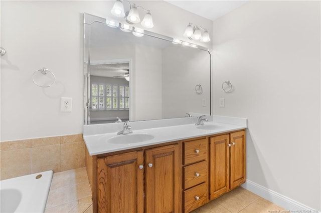 bathroom with tile patterned floors, ceiling fan, a washtub, and vanity