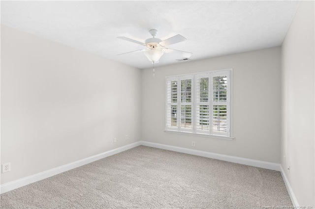 carpeted empty room featuring ceiling fan