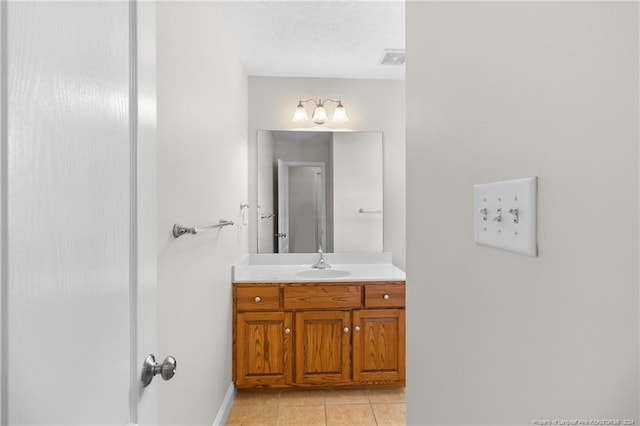 bathroom with tile patterned floors and vanity