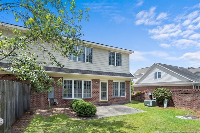 back of house featuring a patio area and a yard