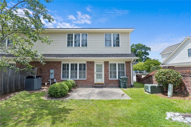 back of property featuring a yard, a patio, and cooling unit