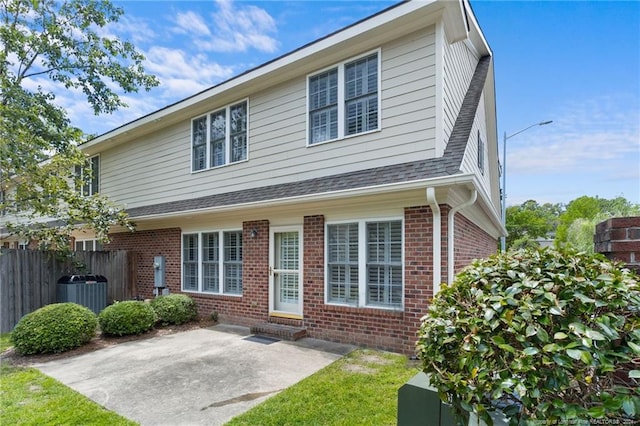 view of property featuring a patio and central AC