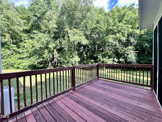 wooden deck featuring a yard