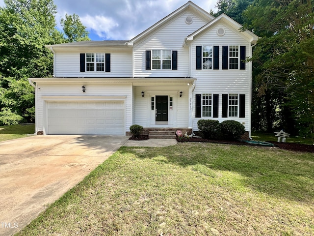 view of front of house featuring a front yard and a garage