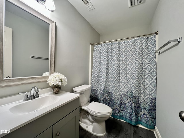 bathroom featuring hardwood / wood-style flooring, vanity, and toilet