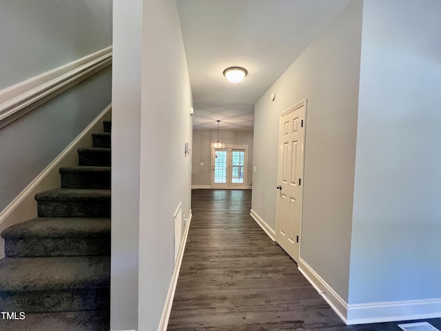 corridor with french doors and dark hardwood / wood-style flooring