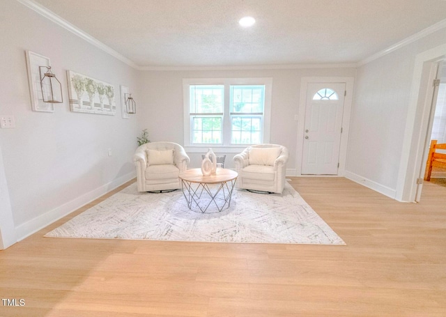 living area with hardwood / wood-style flooring and ornamental molding