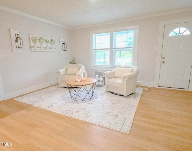 living area featuring ornamental molding and wood-type flooring