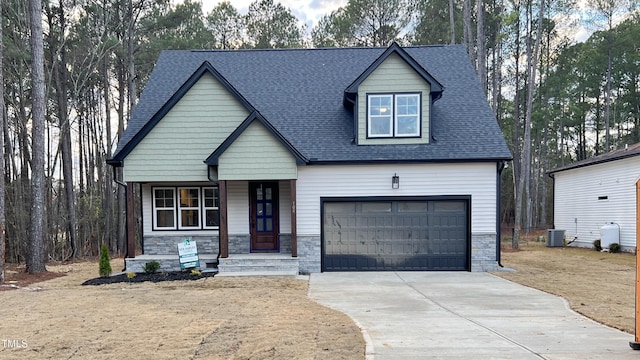 view of front of house featuring cooling unit and a garage