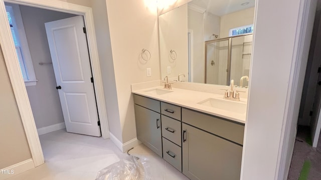 bathroom with tile patterned flooring, vanity, and a shower with door