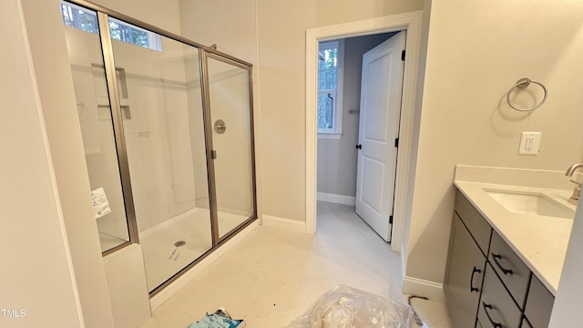 bathroom featuring vanity, tile patterned floors, and a shower with door