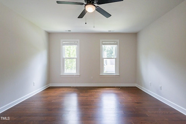 unfurnished room featuring ceiling fan and dark wood-type flooring