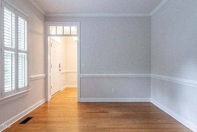 unfurnished room with light hardwood / wood-style flooring and ornamental molding