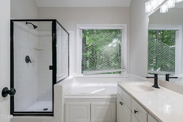 bathroom with plenty of natural light, vanity, and plus walk in shower