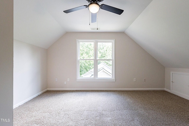 additional living space featuring carpet floors, lofted ceiling, and ceiling fan