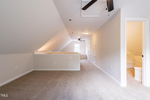 bonus room featuring ceiling fan, light colored carpet, and vaulted ceiling