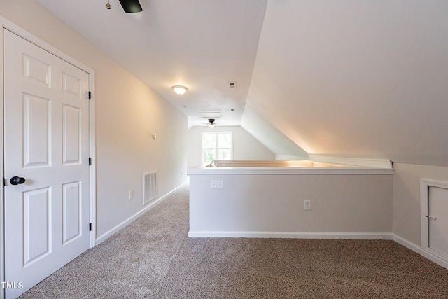 bonus room featuring light carpet, lofted ceiling, and ceiling fan