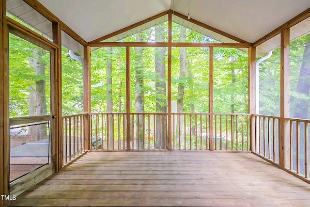 unfurnished sunroom with plenty of natural light and vaulted ceiling