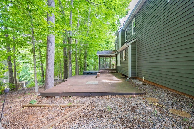 view of yard with a wooden deck and a sunroom