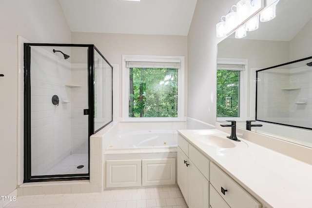 bathroom with vanity, vaulted ceiling, tile patterned floors, and plus walk in shower