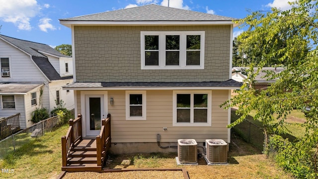 rear view of house featuring central AC unit