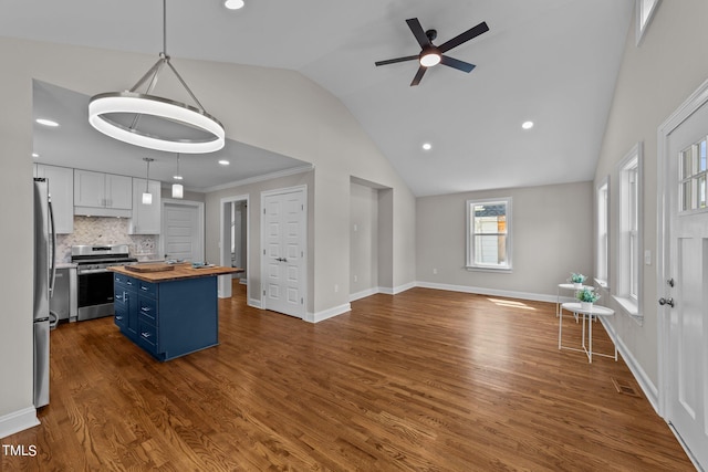 kitchen with white cabinets, hanging light fixtures, stainless steel appliances, blue cabinets, and butcher block countertops