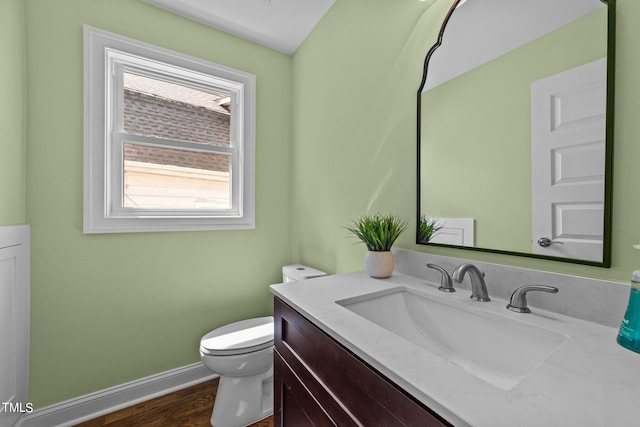 bathroom featuring hardwood / wood-style floors, vanity, and toilet