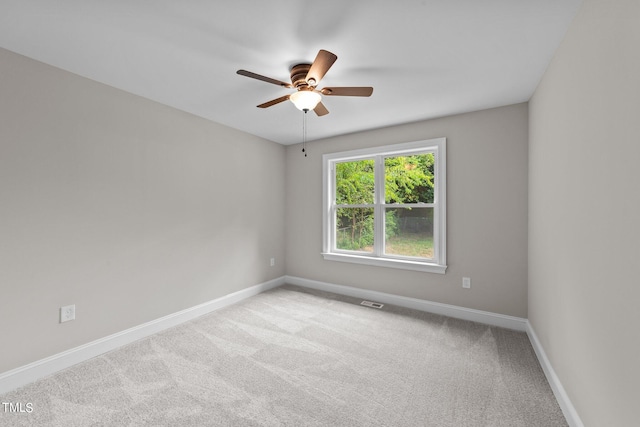 carpeted spare room with ceiling fan