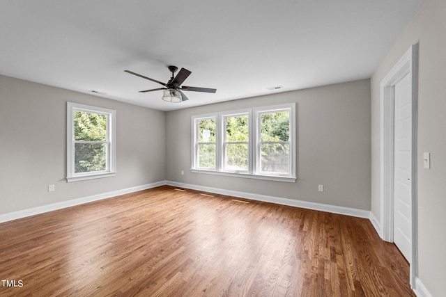 empty room featuring wood-type flooring and ceiling fan