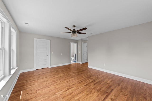 spare room with light wood-type flooring and ceiling fan