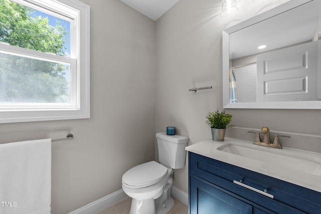 bathroom with vanity, toilet, and tile patterned floors