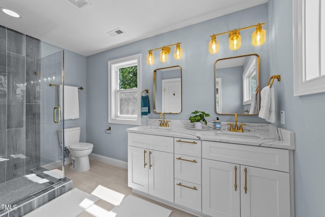 bathroom featuring walk in shower, vanity, toilet, and tile patterned floors