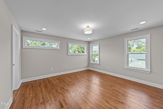 unfurnished room featuring wood-type flooring and a wealth of natural light