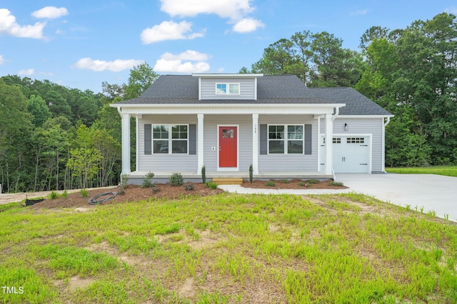 view of front facade featuring a garage, a front yard, and covered porch