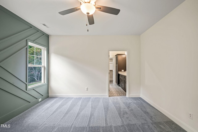 spare room featuring ceiling fan, carpet flooring, and lofted ceiling