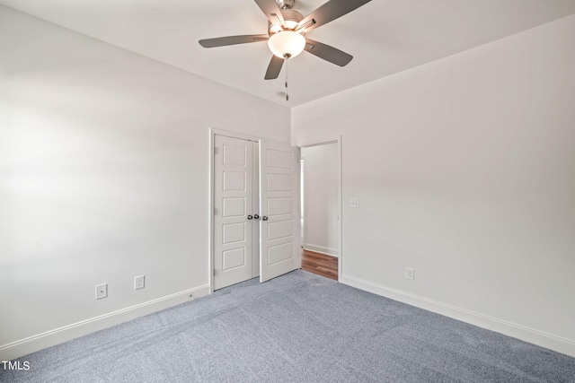 carpeted empty room featuring ceiling fan