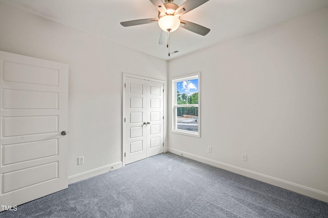 empty room featuring ceiling fan and carpet flooring