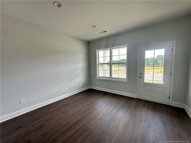 spare room with dark hardwood / wood-style floors