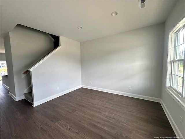 empty room featuring dark wood-type flooring