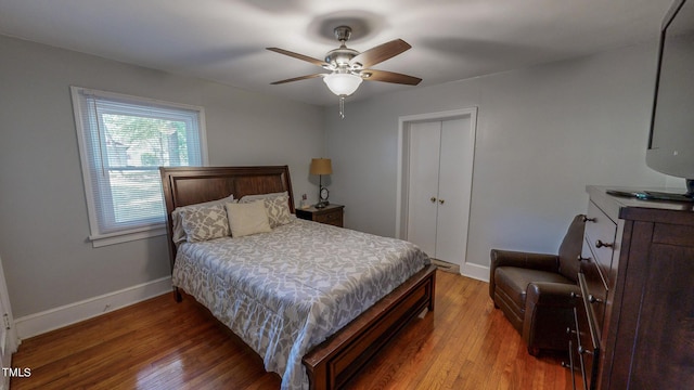 bedroom with hardwood / wood-style flooring, a closet, and ceiling fan